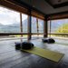 Yoga-Raum mit Blick auf Berge und zwei Matten mit Kissen