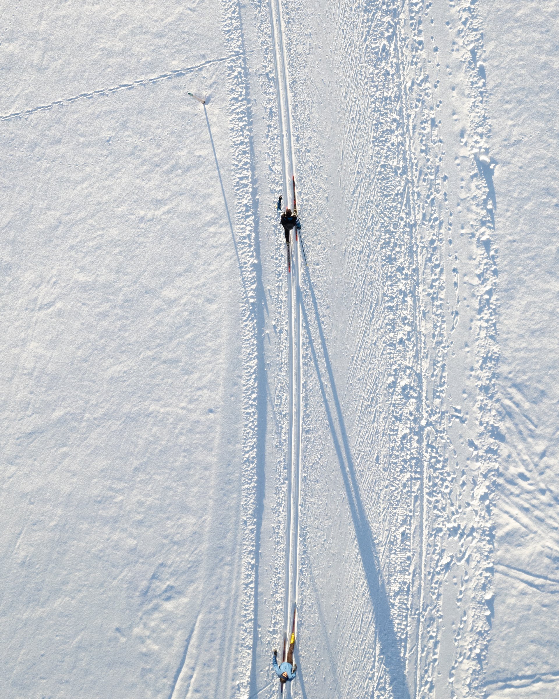 Wellness and luxury: your hotel in Tyrol Two people cross-country skiing on fresh snow viewed from above